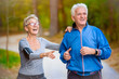 © lordn - Smiling senior couple jogging in the park