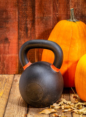 Wall Mural - kettlebell and pumpkins against weathered wood