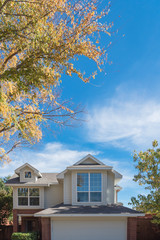 Wall Mural - Single-detached dwelling home in suburban Dallas-Fort Worth with attached garage. Colorful autumn fall foliage in North America.