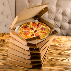 Canvas Print - pizza in box on wooden background, pizza delivery