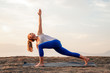 Fit Woman Doing Reaching Yoga Pose at Sunset
