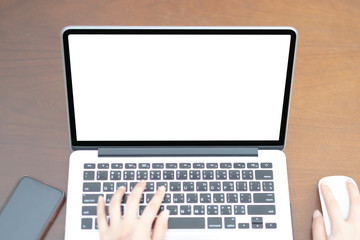 Wall Mural - close-up hand typing keyboard computer showing white screen in coffee shop