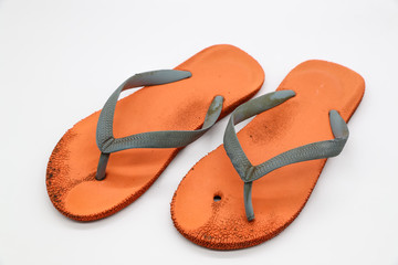 broken orange flip flops isolated and white background