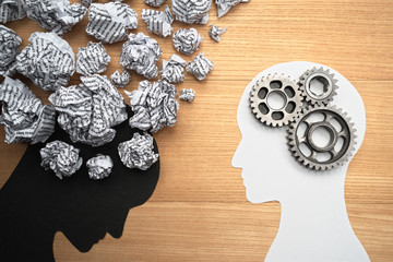 Wall Mural - Mental health image. Silhouette of depressed person brain and healthy person brain. Waste paper, gears and head silhouette.