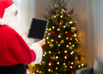 Wall Mural - holidays, technology and people concept - santa claus with tablet pc computer over christmas tree background