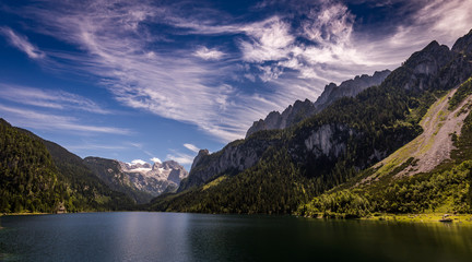 Wall Mural - Idyllic, scenic view with dramatic clouds on Dachstein with glacier from Vorderer Gosausee in Alps, Austria 