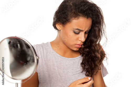 Portrait Of Young Dark Skinned Woman With Hair Splitting Problem