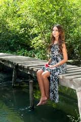 Wall Mural - Pretty girl sits on pedestrian bridge