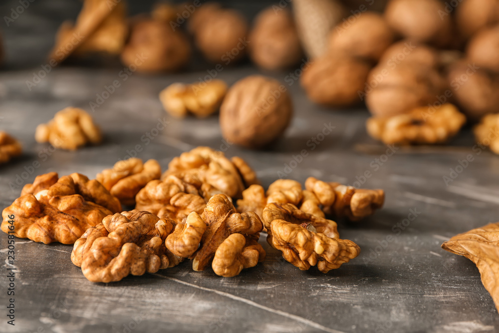 Shelled walnuts on grey table