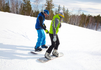 Canvas Print - Young   snowboarders   in ski resort