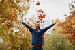 © marjan4782 - Young man throwing autumn leaves in the air