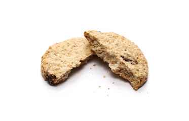Wall Mural - Round cracked wholewheat biscuit, cookie with raisins and crumbs isolated on white background