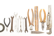 Rusty And Old Tools Arranged In A Row On A White Background Top View