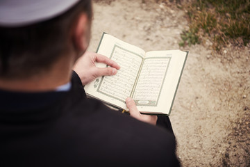 Wall Mural - quran holy book reading by imam  on islamic funeral