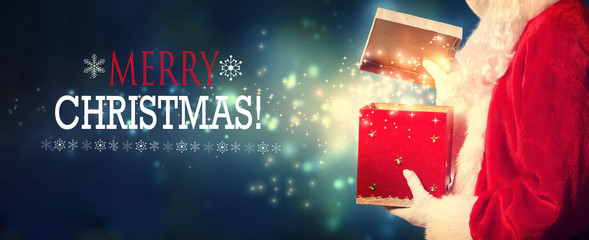 Wall Mural - Merry Christmas message with Santa opening a gift box on a shiny light background