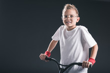 Portrait Of Stylish Boy In Eyeglasses With Scooter On Black Backdrop