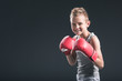 © LIGHTFIELD STUDIOS - portrait of cheerful boy with red boxing gloves on black backdrop