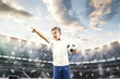 Young boy with soccer ball doing flying kick at stadium. football soccer players in motion on sky background. Fit jumping boy in action, jump, movement at game. Collage