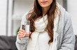 © LIGHTFIELD STUDIOS - cropped shot of young woman in warm clothes holding glass of water