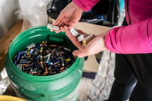 Batteries Being Disposed Of In Recycling Center, Hands Of Woman 