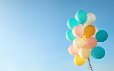 Sticker - Bunch of colorful balloons against clear blue sky. Space for text