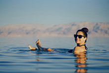 Brunette Girl Swimming In The Dead Sea