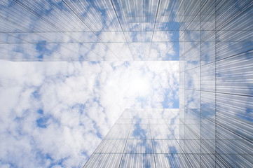 glass facade of a modern building reflecting clouds