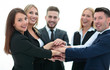 © ASDF - friendly business team with hands clasped together.