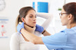 © Kalim - Female doctor putting neck orthopaedic collar on adult injured woman