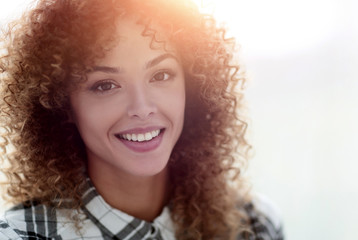 Wall Mural - Portrait of a beautiful young woman with curly hair.