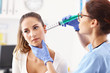 © Kalim - Adult woman having a visit at female laryngologist's office