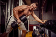 © zamuruev - Strong Bodybuilder Doing Heavy Weight Exercise For Back with Dumbbell