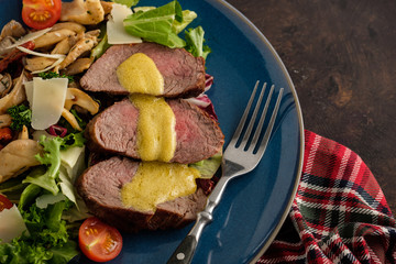 Wall Mural - Salad with warm beef with oyster mushrooms, tomatoes and greens. Top view