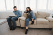© Vadym - Bored couple ignore each other. Young people chatting online using smart phone and laptop. Internet and gadget addiction. Lack of communication, technology overuse.