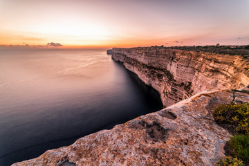 Sticker - Ta Cenc cliffs at sunset.  These massive walls overlook the Mediterranean Sea.  Island of Gozo, Malta.  