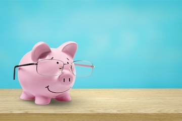  Pink piggy bank in glasses on background