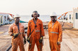 Seamen crew AB or Bosun on deck of offshore vessel or ship , wearing PPE personal protective equipment - helmet, coverall, lifejacket, goggles. Towing team