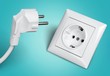 White electrical plug in the electric socket
