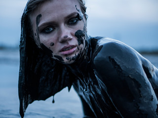 Portrait of Blonde Lays Smeared in a Healthy Black Mud