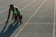 © Wavebreak Media - Male athlete in starting position on running track