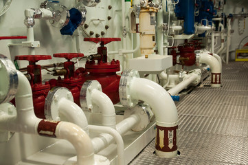 Wall Mural - Equipment, cables, pipes and valves in engine room of a ship power plant