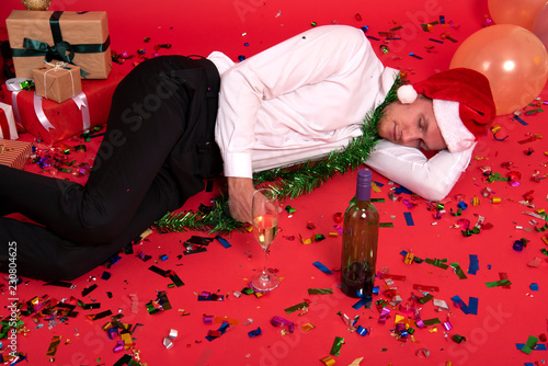 Fotografie, Obraz Young businessman hangover sleeping after drinking of alcohol in office