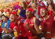 © Alex - Young sport supporter happy fans cheering at stadium. Group of young woman and man support the football team during the match
