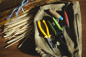 Tools for weaving of wicker table in the workshop. Flat lay.