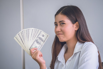 Business woman showing bill of dollars  with smiling to successful for work.