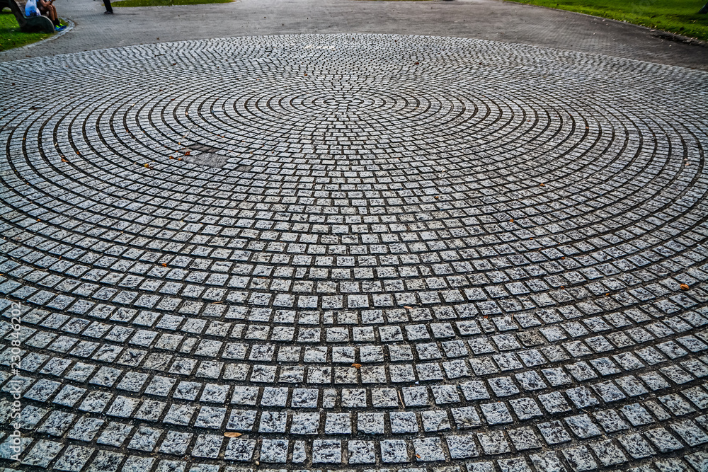circular design cobblestone park ground surface with trees all around