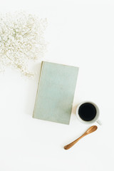 Wall Mural - Home office desk with coffee, book, flowers on white background. Flat lay, top view.