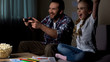 © motortion - Excited father and daughter playing video game, female kid raising hands, winner