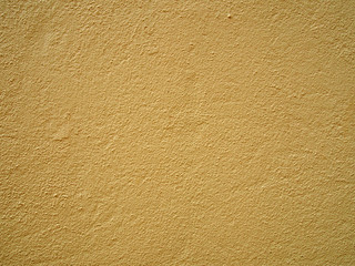 Wall Mural - a pale yellow concrete grainy textured wall painted a bright light yellow color