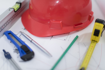 Architectural Office desk ,Desk table with construction tools, red helmet construction, pen, Pencil, Ruler and paper roll. Business concept.